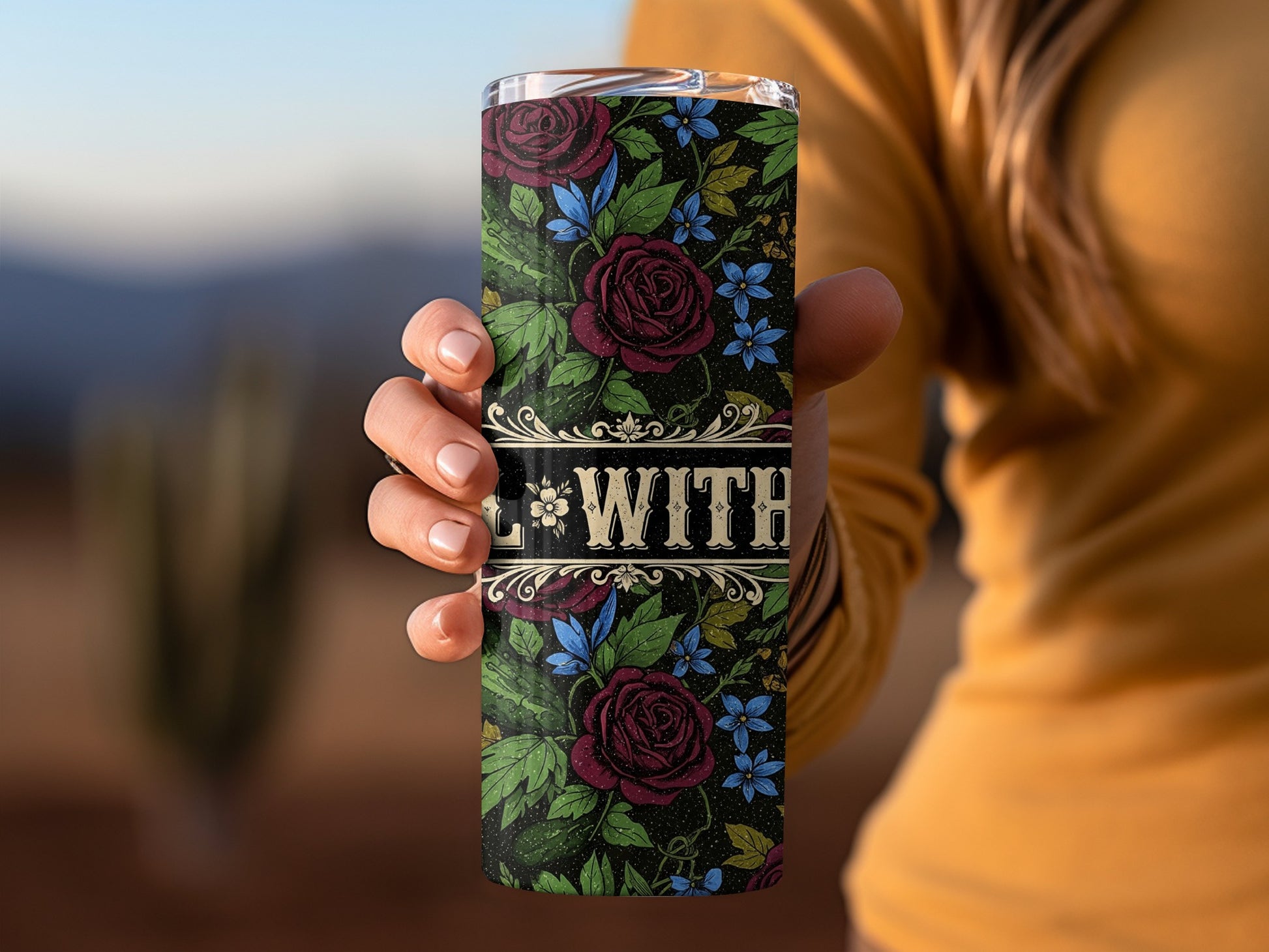 Tumbler with floral pattern, roses and blue flowers, and "WITH" text.