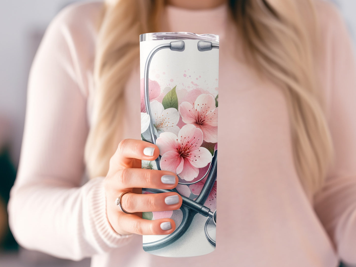 Tumbler with stethoscope and pink cherry blossoms.