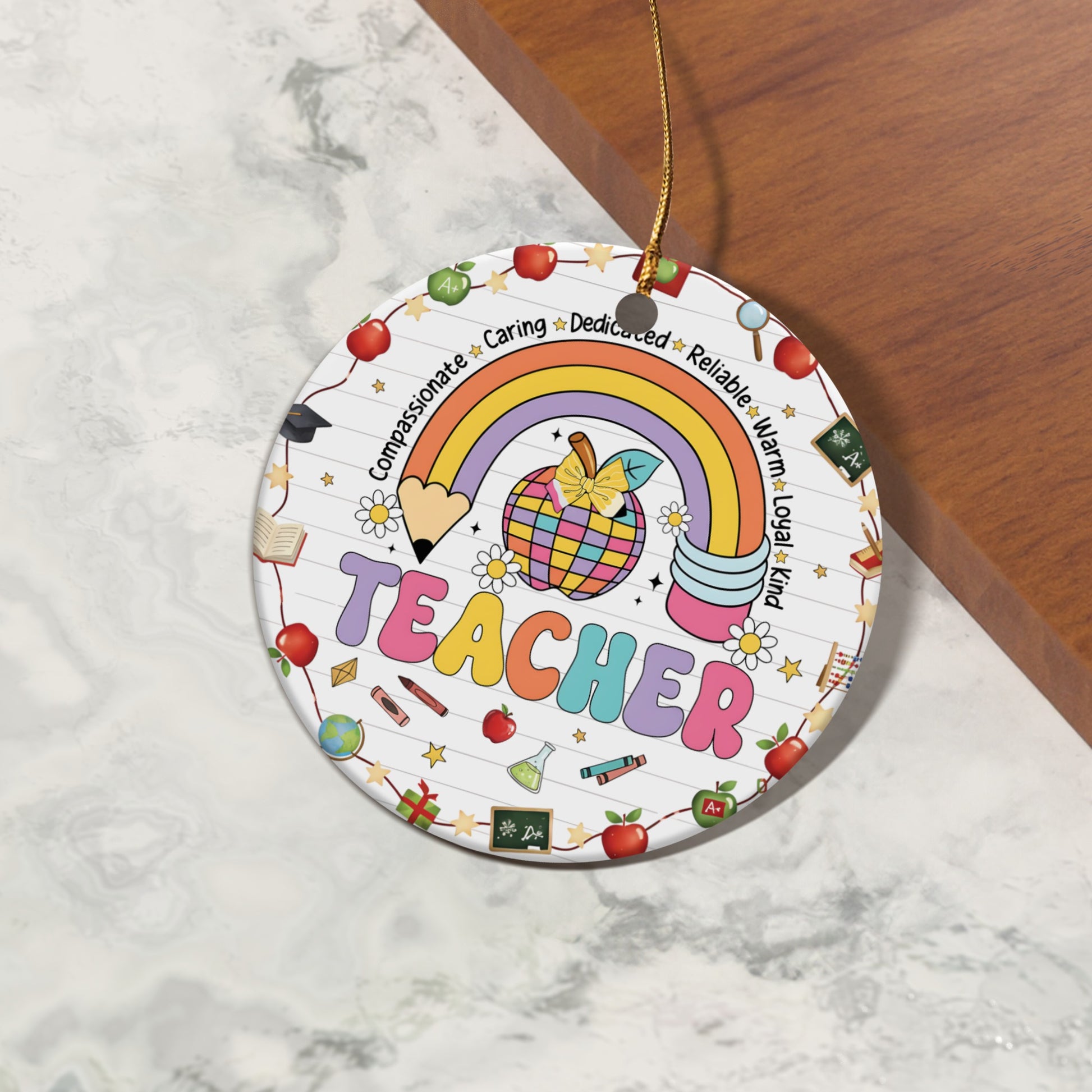 Round ornament with "TEACHER" text, rainbow, apple, and school-themed icons.