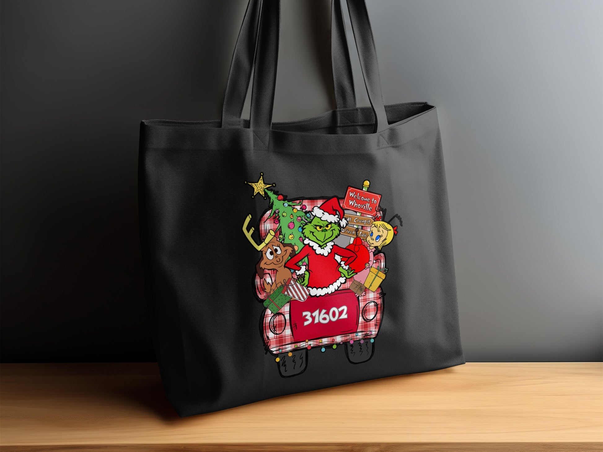 Black tote bag with a festive Grinch and Whoville Christmas scene.