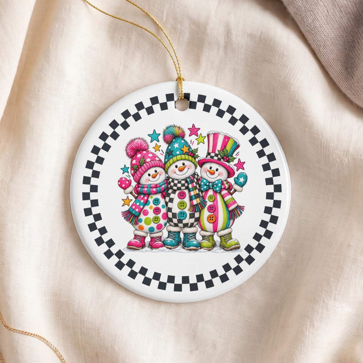 Three cheerful snowmen with colorful hats, scarves, and boots on a round ornament.