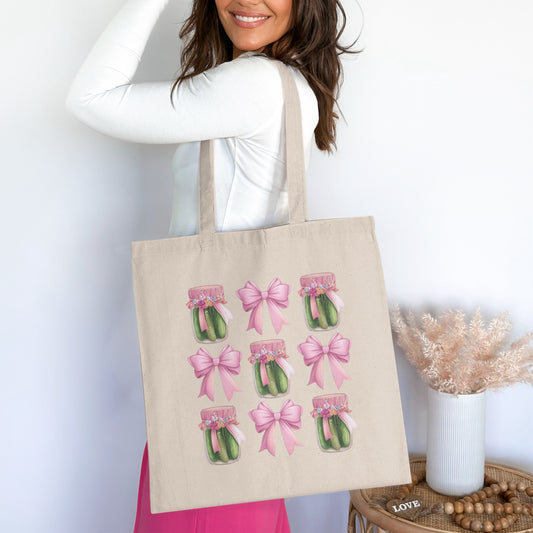 Beige tote bag with repeating pattern of pickle jars adorned with pink bows.