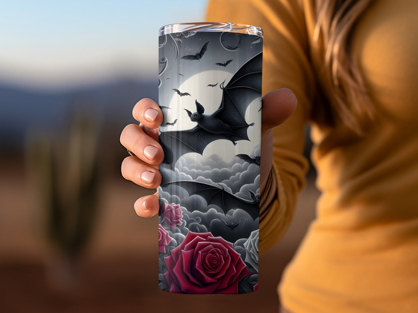 Tumbler with bats and red roses against a cloudy moonlit sky.