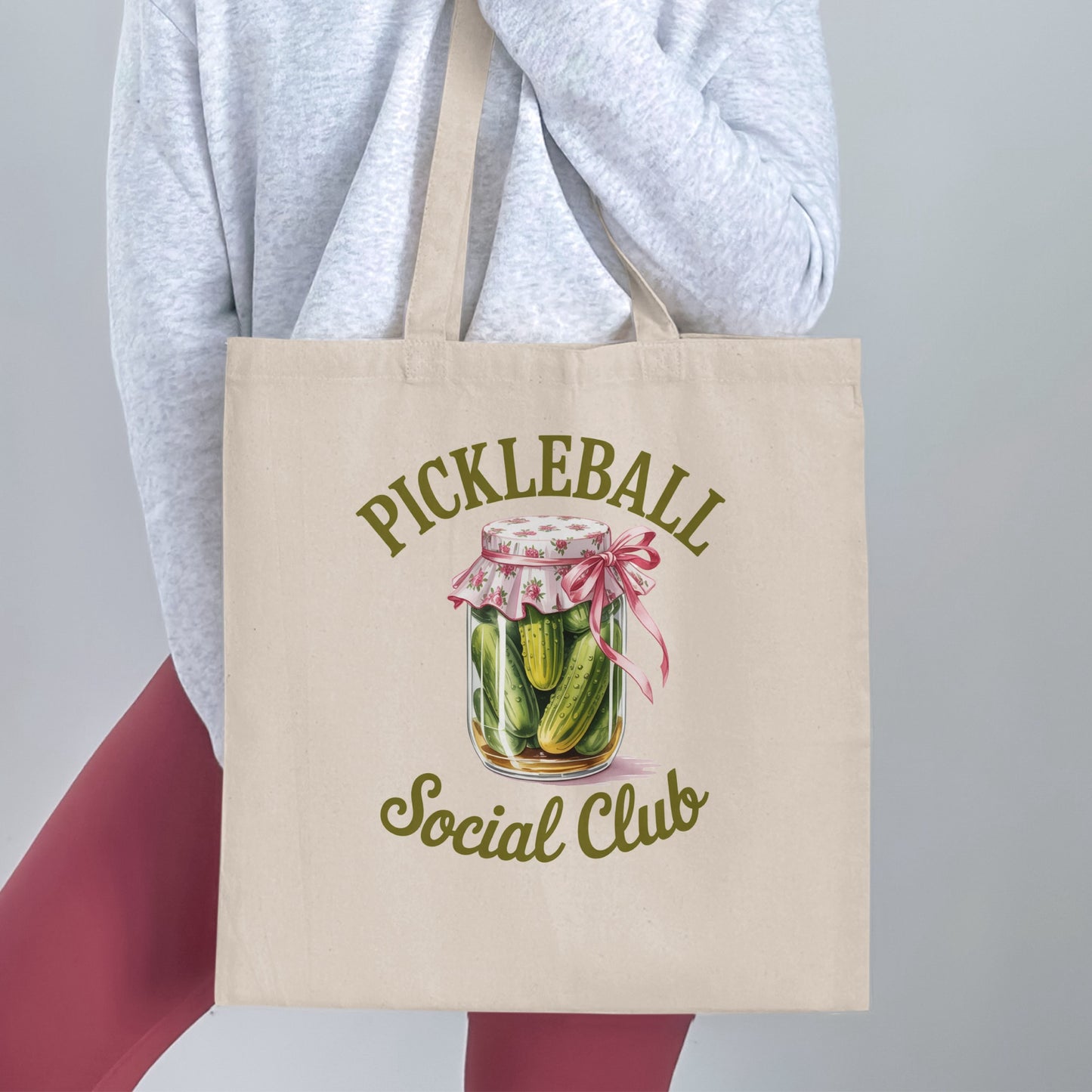 Beige tote bag with "Pickleball Social Club" logo featuring a jar of pickles.