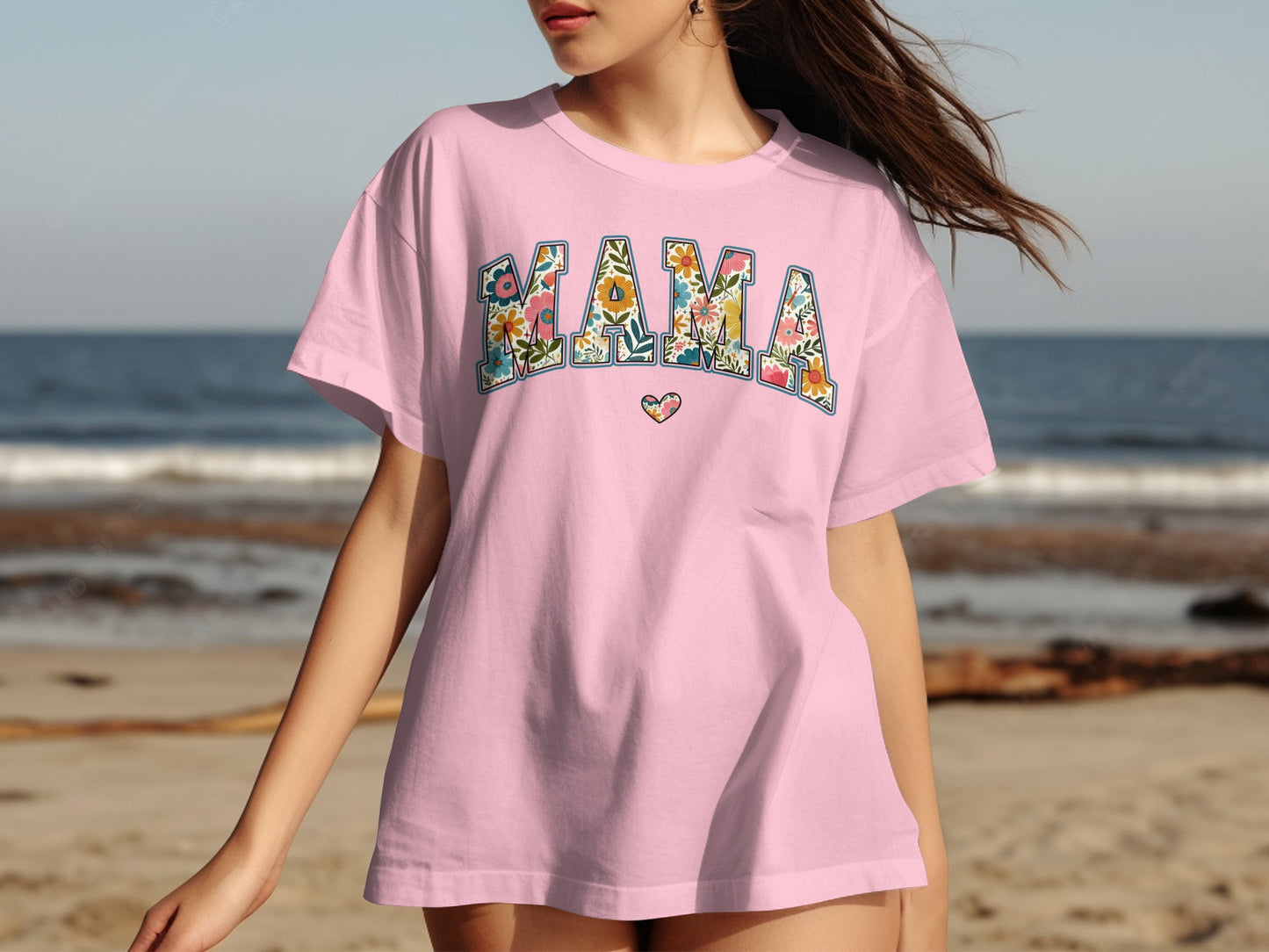 Pink t-shirt with "MAMA" in floral letters and a small heart.