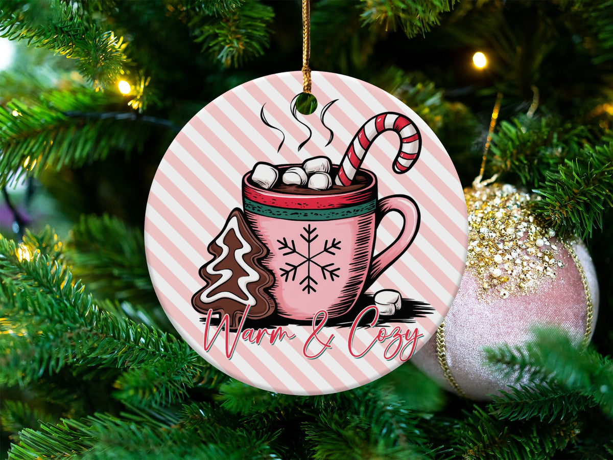 Round ornament with pink stripes, hot chocolate, gingerbread, and candy cane.