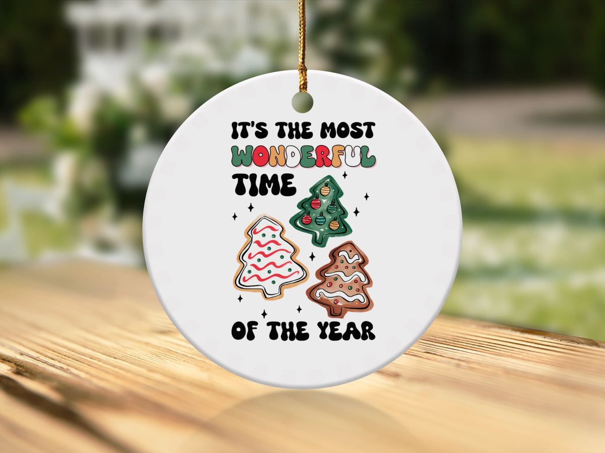 Round ornament with "It's the most wonderful time of the year" and Christmas tree cookies.