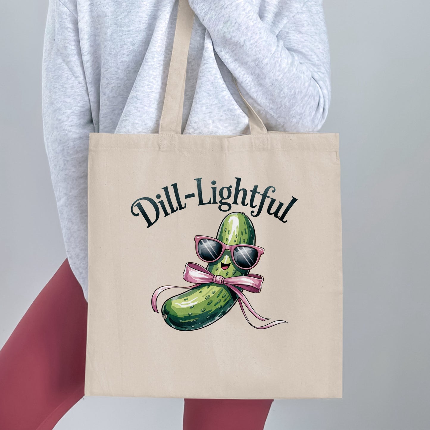 Tote bag with a smiling pickle wearing sunglasses and a pink bow.
