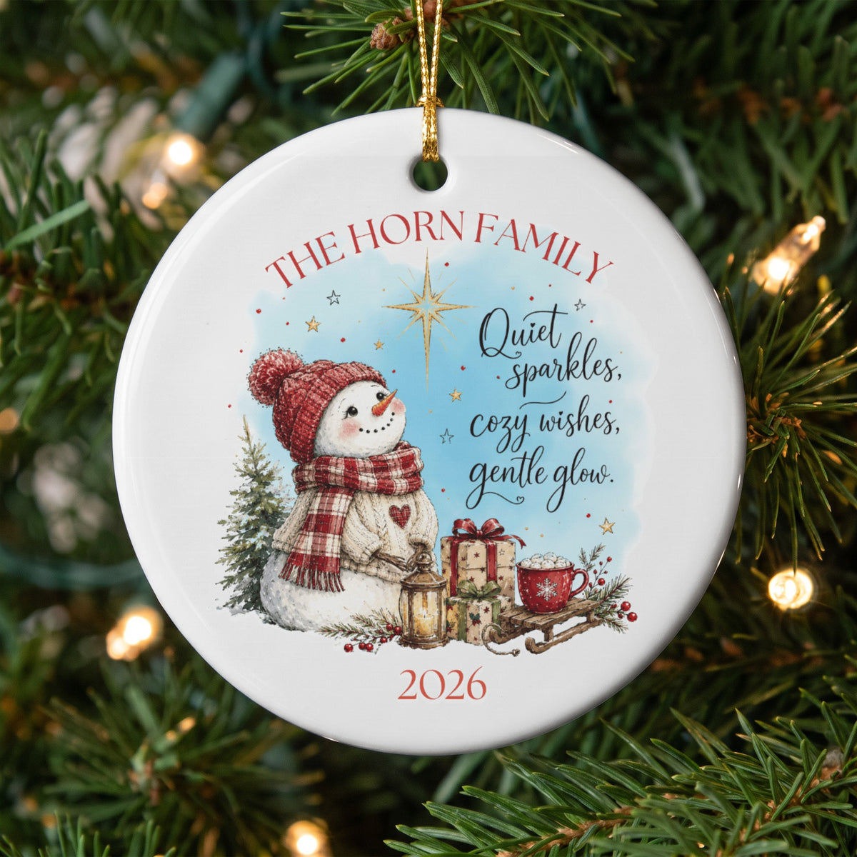 Round white ceramic Christmas ornament featuring a snowman, presents, and the text The Horn Family and 2026.