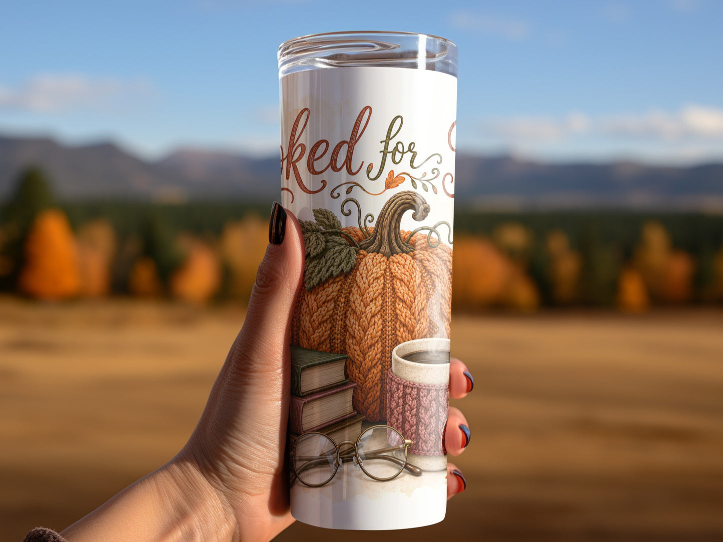 Tumbler with knit pumpkin, books, glasses, and coffee cup design.