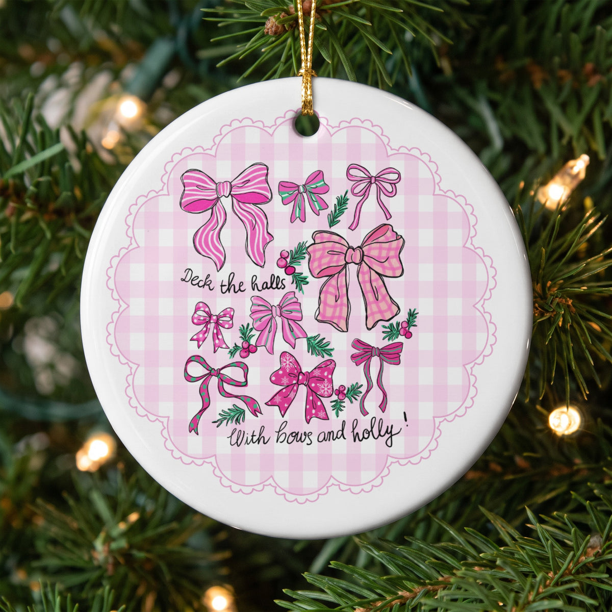 Christmas ornament with pink bows and holly, reads "Deck the halls with bows and holly!".
