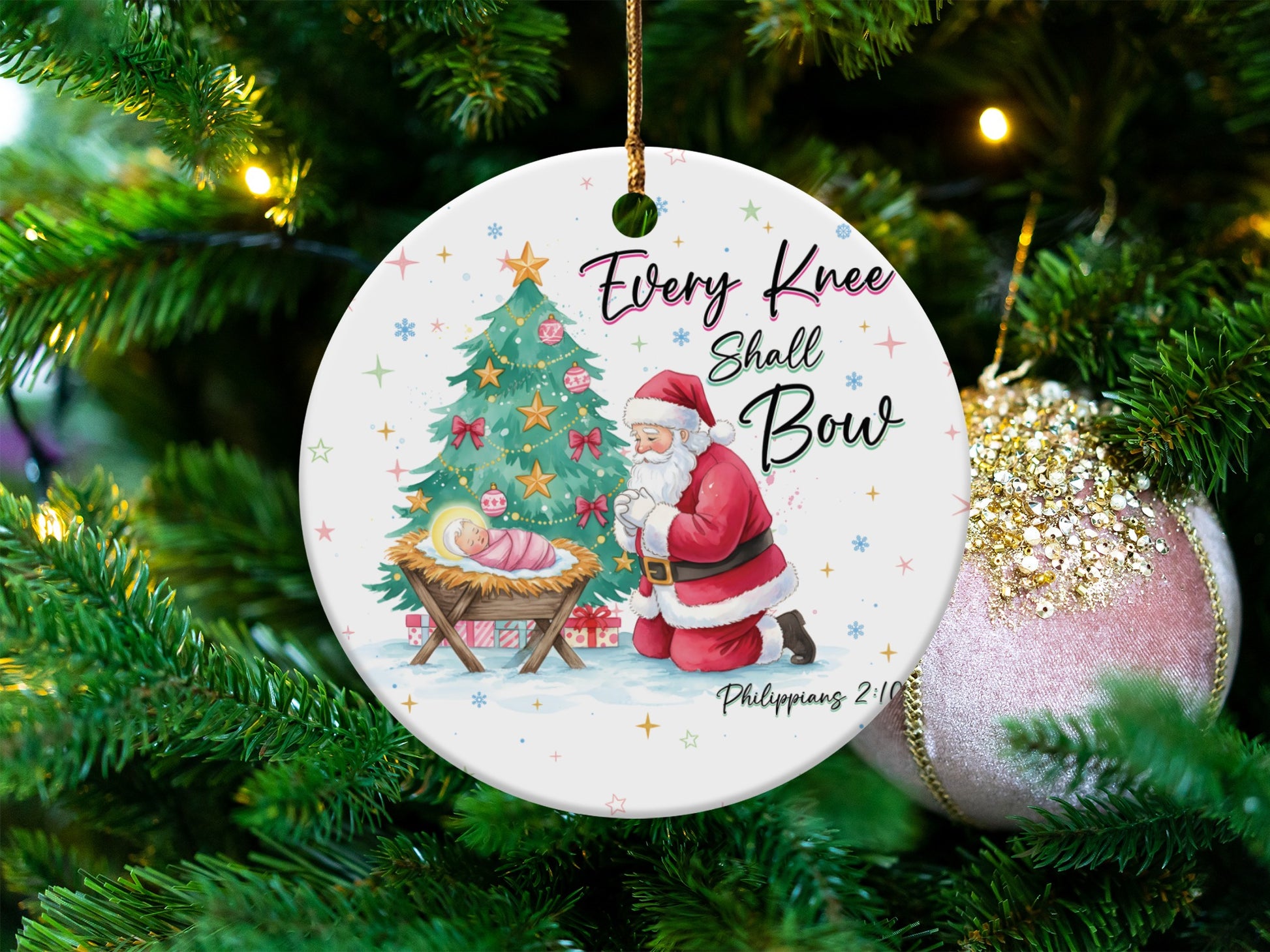 Ornament with Santa kneeling before baby Jesus, inscribed "Every Knee Shall Bow."