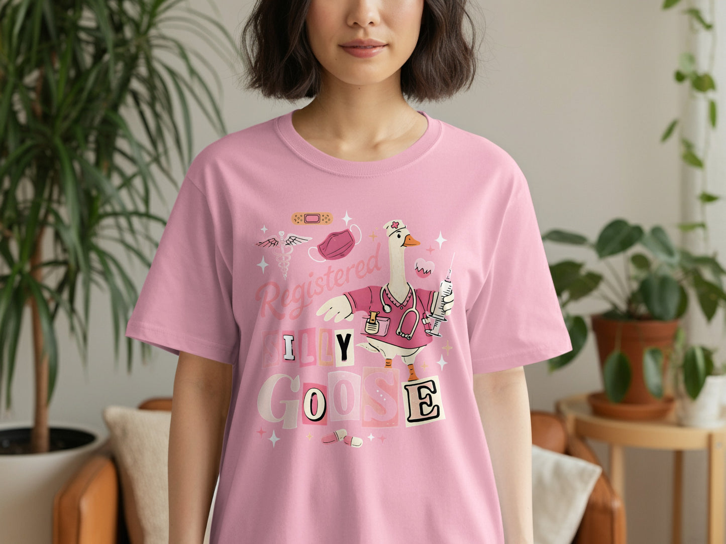 Pink t-shirt with "Registered Goose" text and cartoon goose wearing scrubs.
