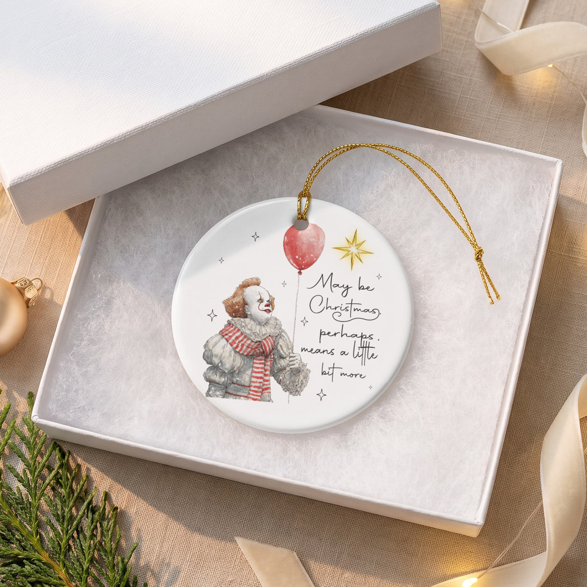 Ornament with clown holding red balloon and text "May be Christmas, perhaps means a little bit more."