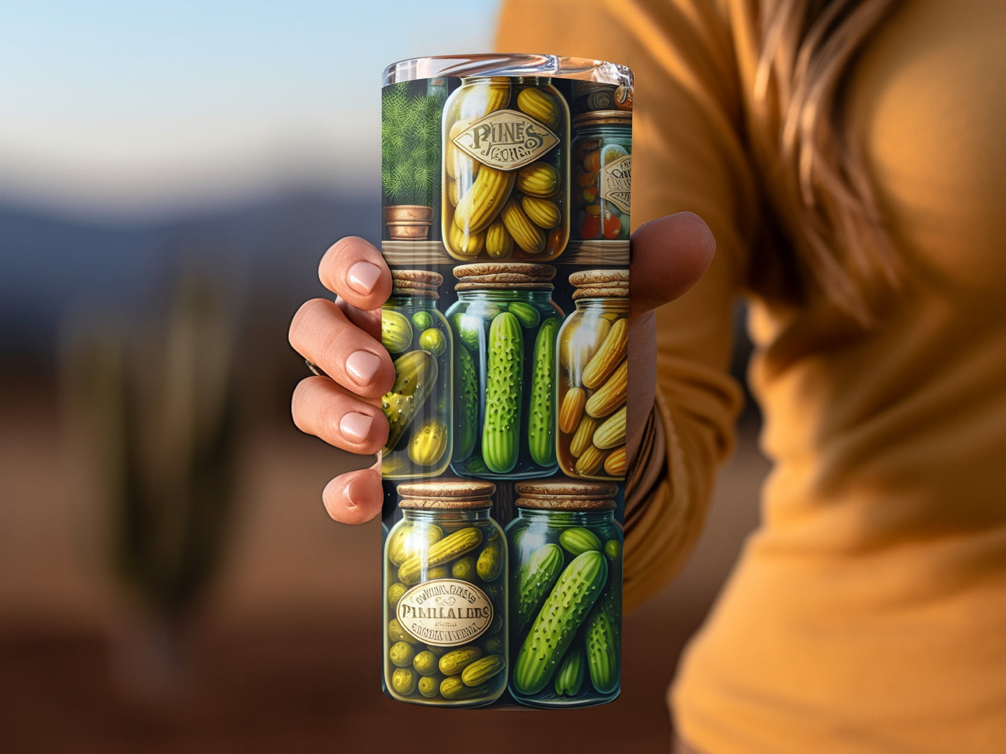 Stack of six jars of pickles held by a person's hand.