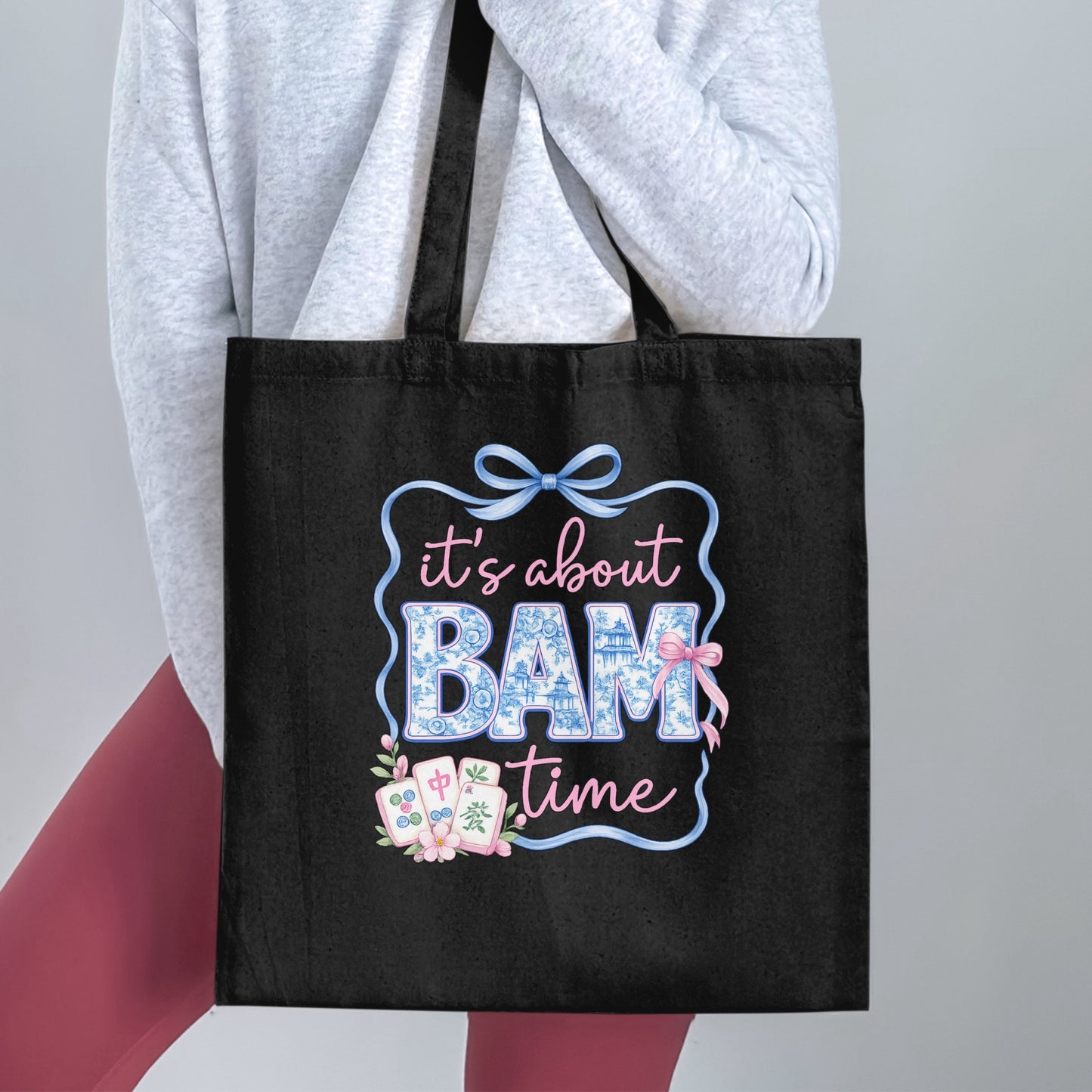 Black tote bag featuring "it's about BAM time" and mahjong tiles.