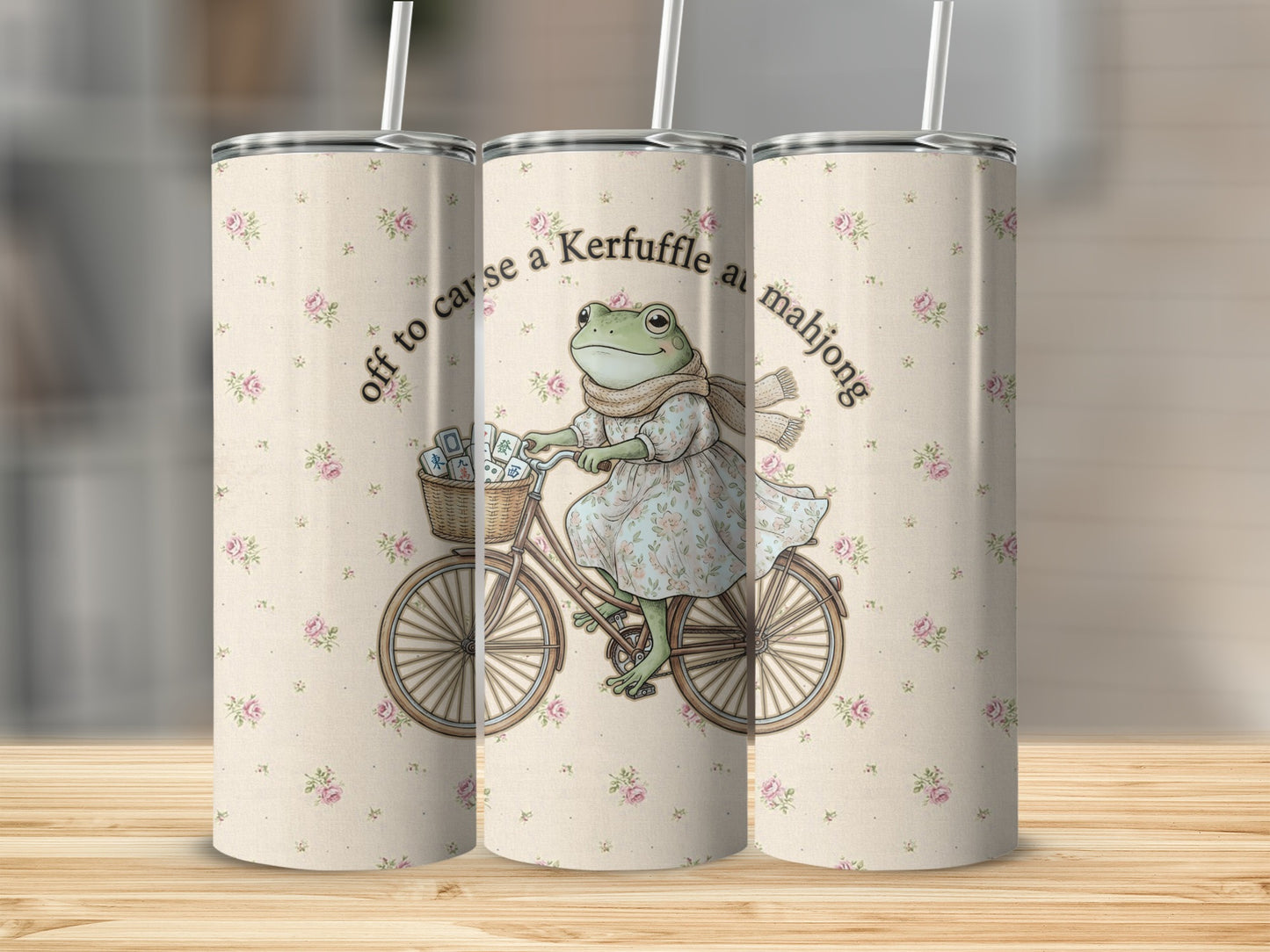 Frog in floral dress and scarf rides bicycle with mahjong tiles; text "off to cause a Kerfuffle at mahjong".