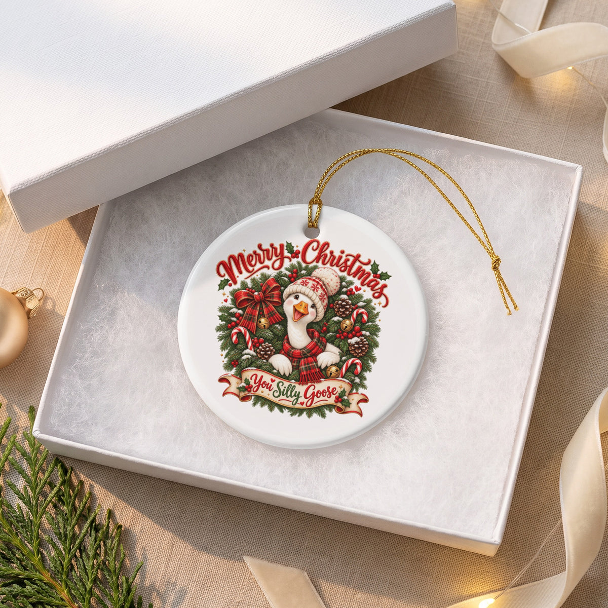 Christmas ornament with a goose in a Santa hat saying "You Silly Goose".
