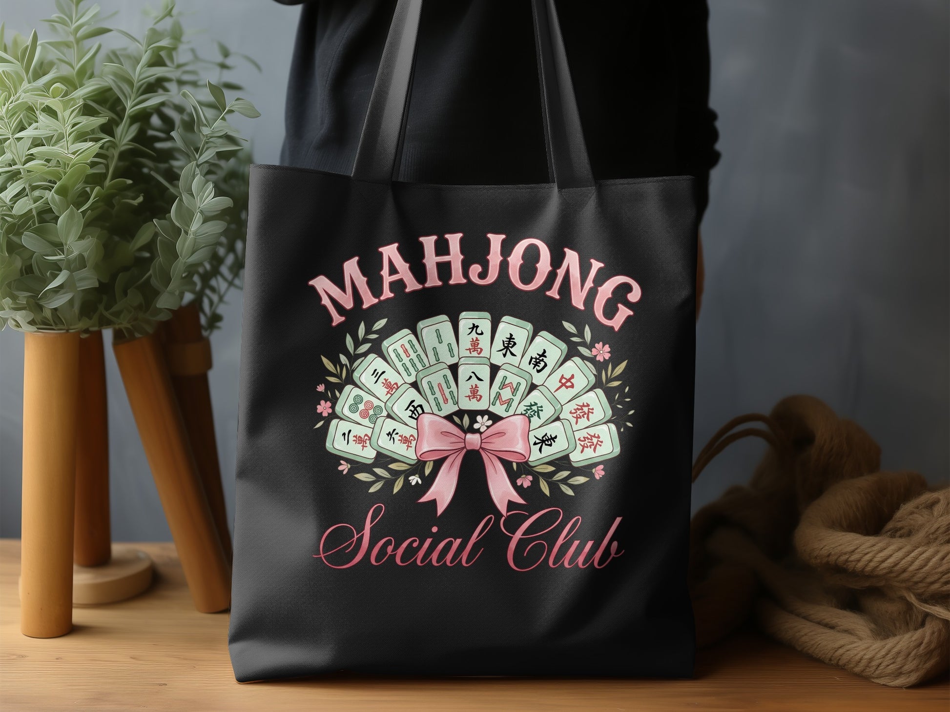 Black tote bag with "Mahjong Social Club" text and mahjong tiles design.