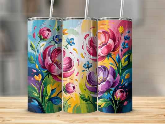 Three colorful tumblers featuring vibrant floral designs on a wooden surface.