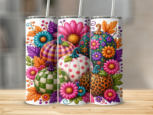 Three tumblers with colorful, patterned pumpkins and floral designs.