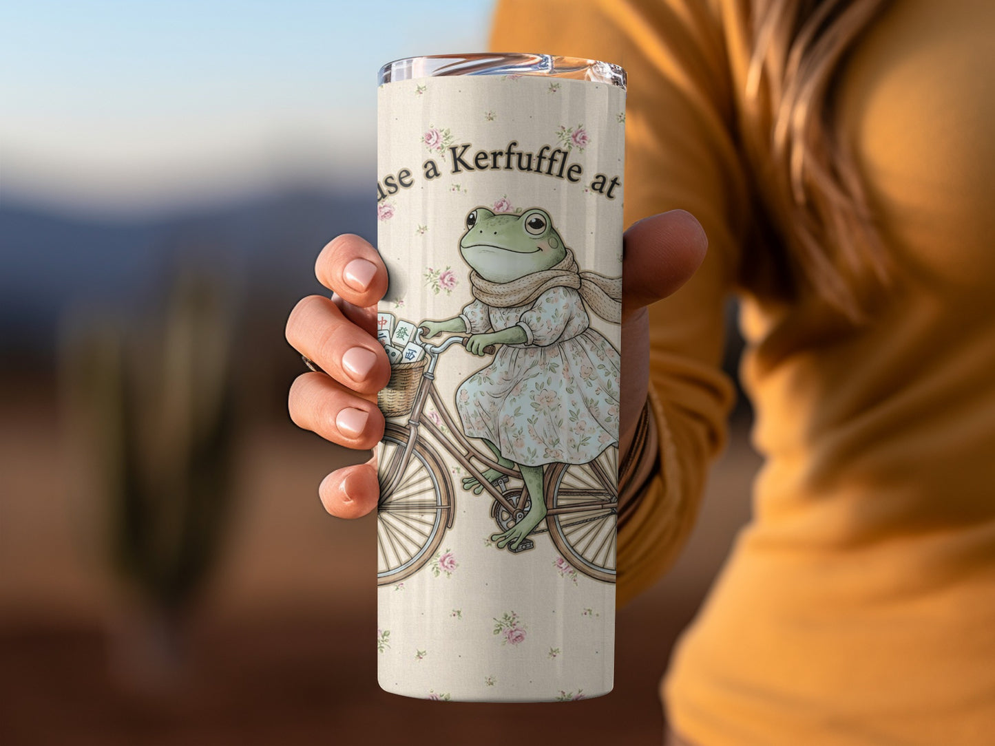 Tumbler with a frog on a bicycle and text stating "use a Kerfuffle at".