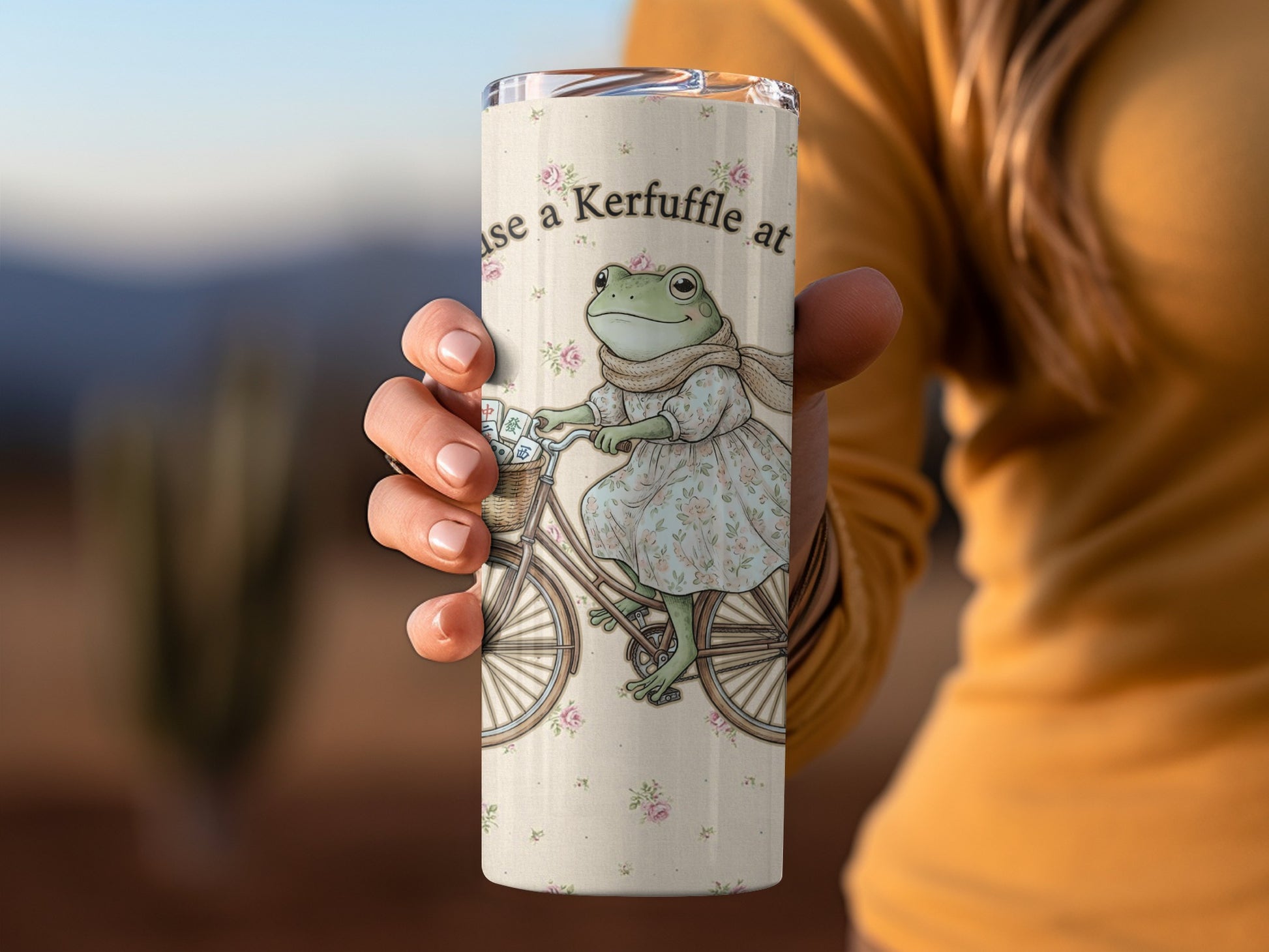 Tumbler with a frog on a bicycle and text stating "use a Kerfuffle at".