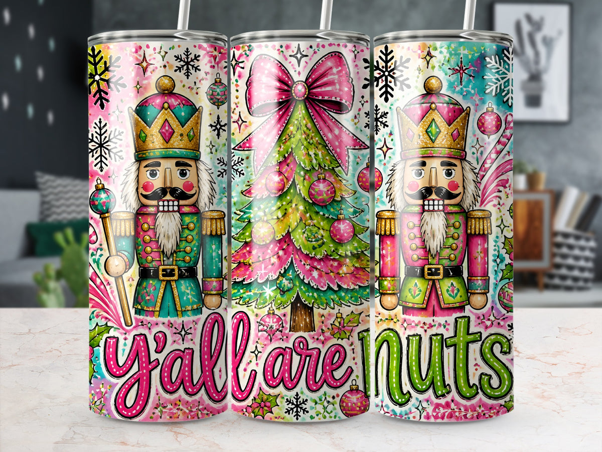 Three stainless steel tumblers feature a colorful Christmas nutcracker design with the phrase y'all are nuts.