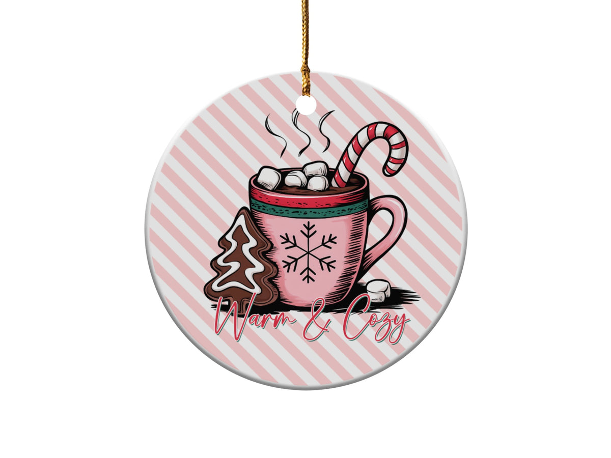 Round ornament with hot chocolate, gingerbread tree, candy cane, and "Warm & Cozy" text.