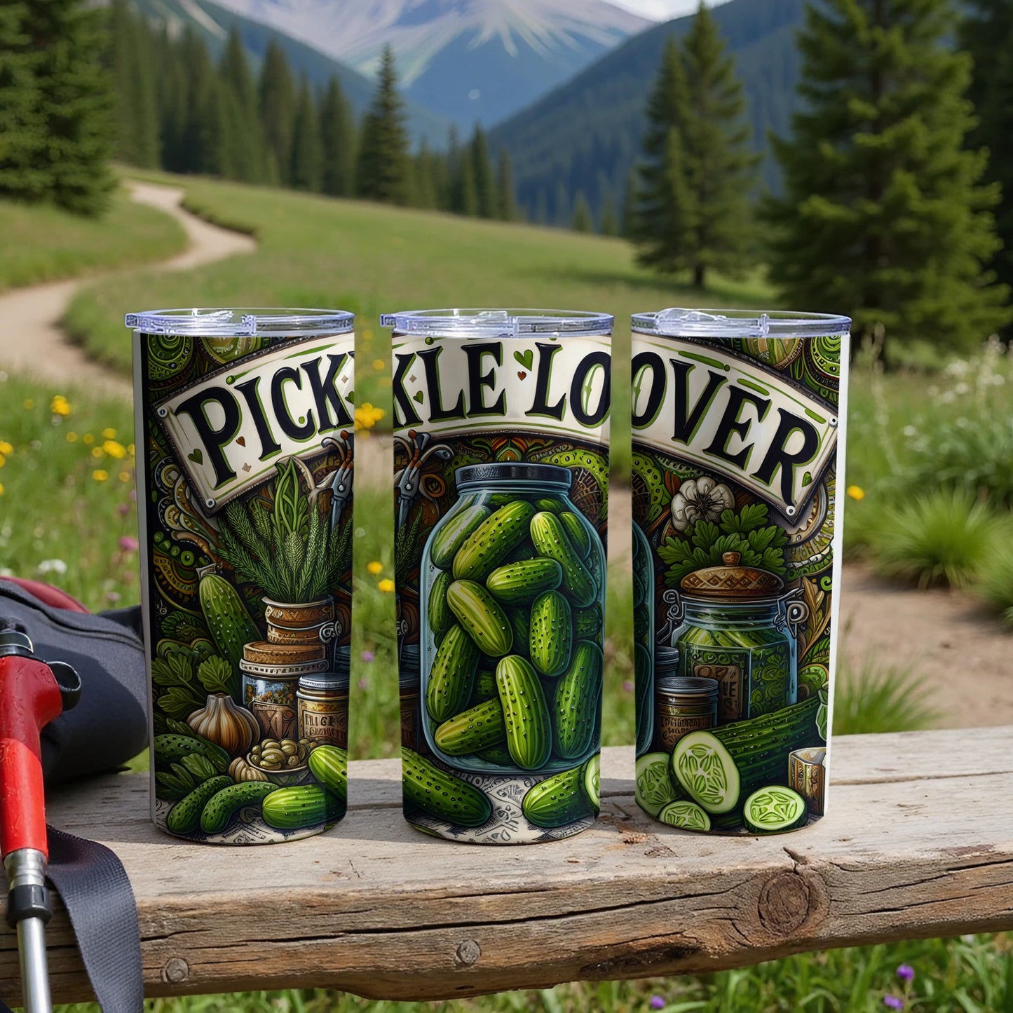 Three tumblers with pickle-themed art and "pickle lover" text in a scenic outdoor setting.