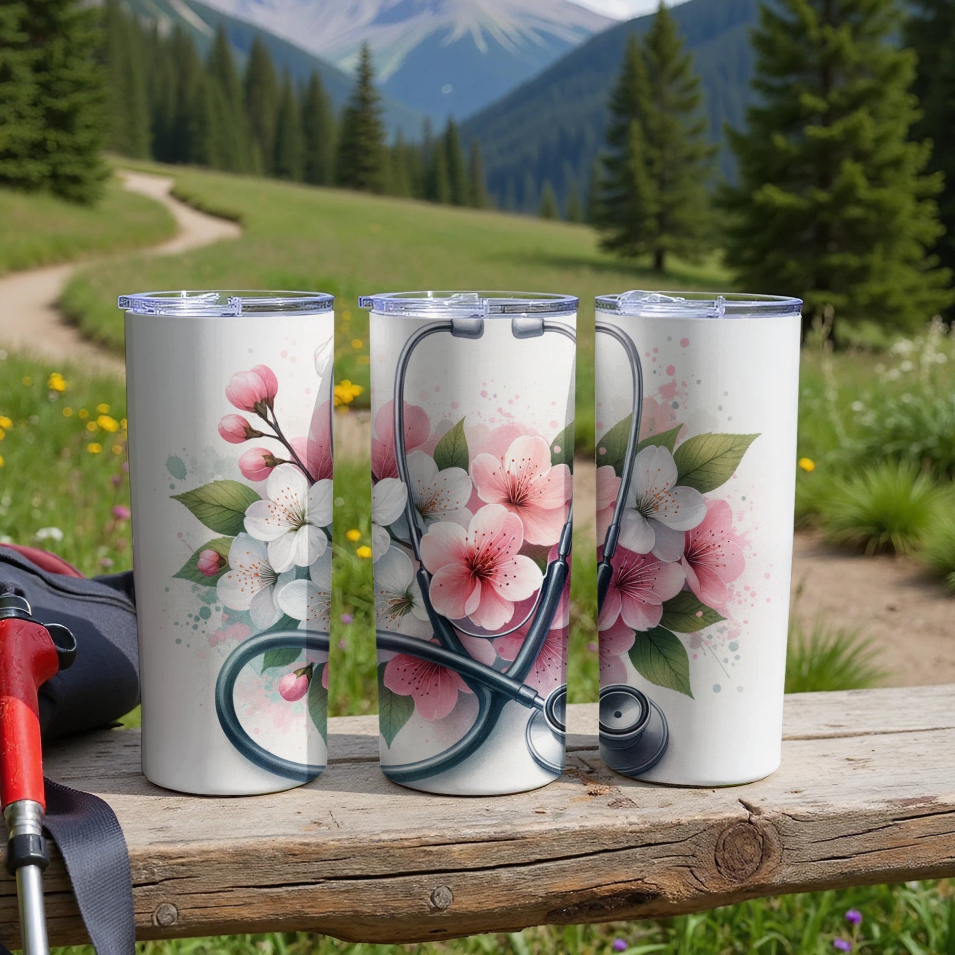 Three stainless steel tumblers with cherry blossom and stethoscope floral design.