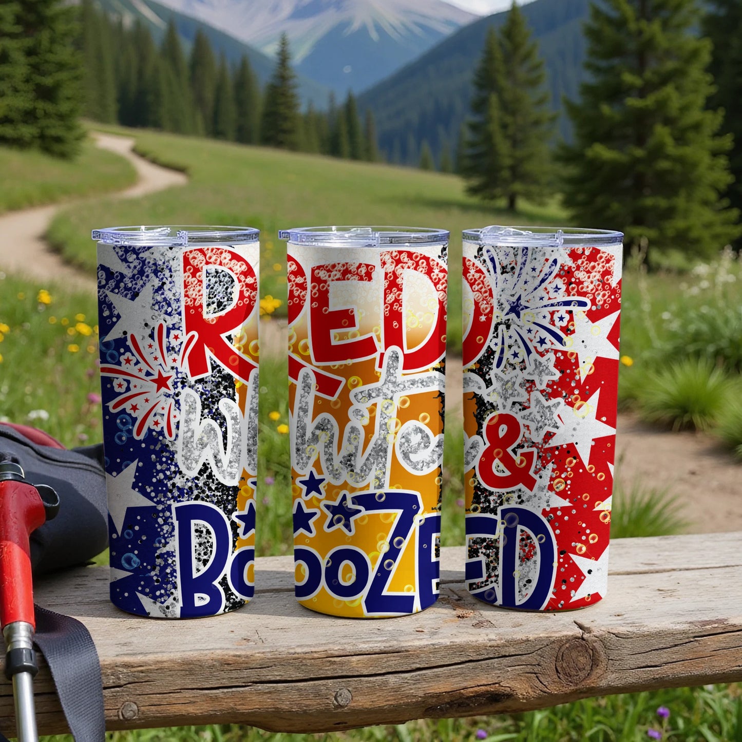 Three patriotic tumblers with "Red White & Boozed" text in a mountain landscape.