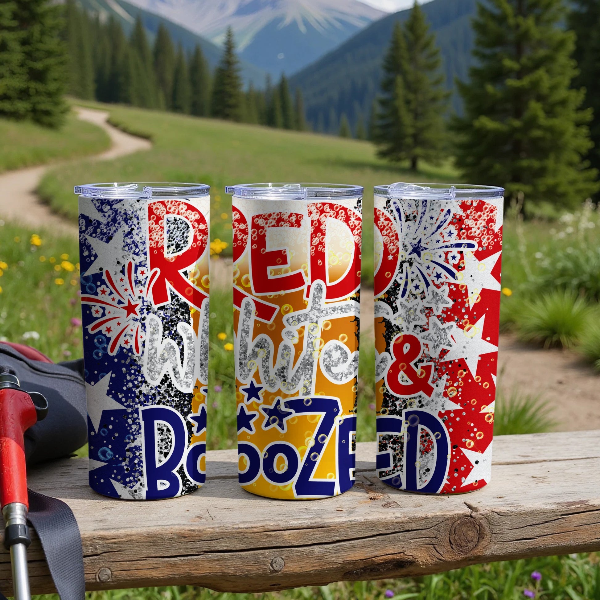 Three patriotic tumblers with "Red White & Boozed" text in a mountain landscape.