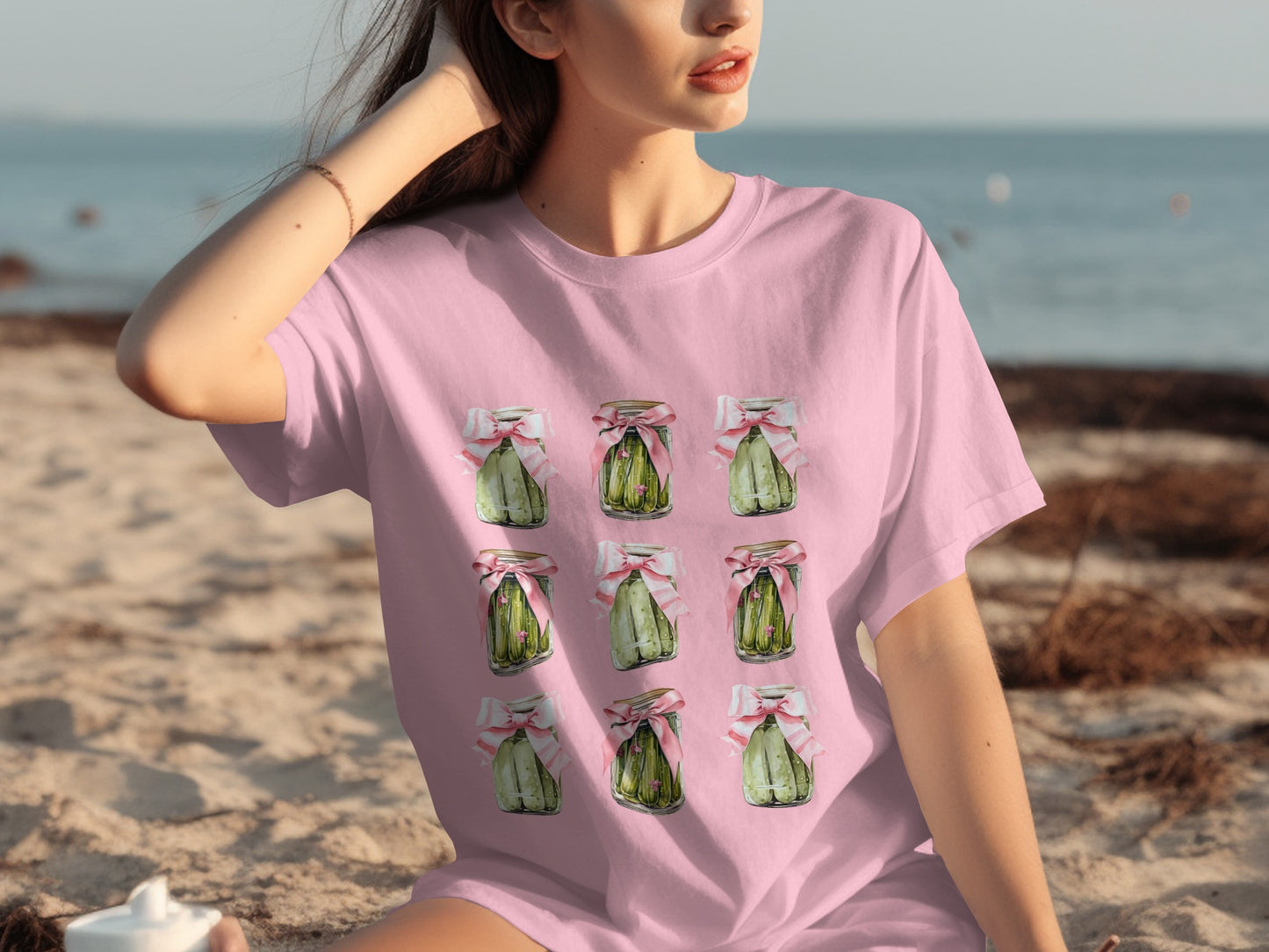 Pink t-shirt with a repeating pattern of green jars tied with pink ribbon.