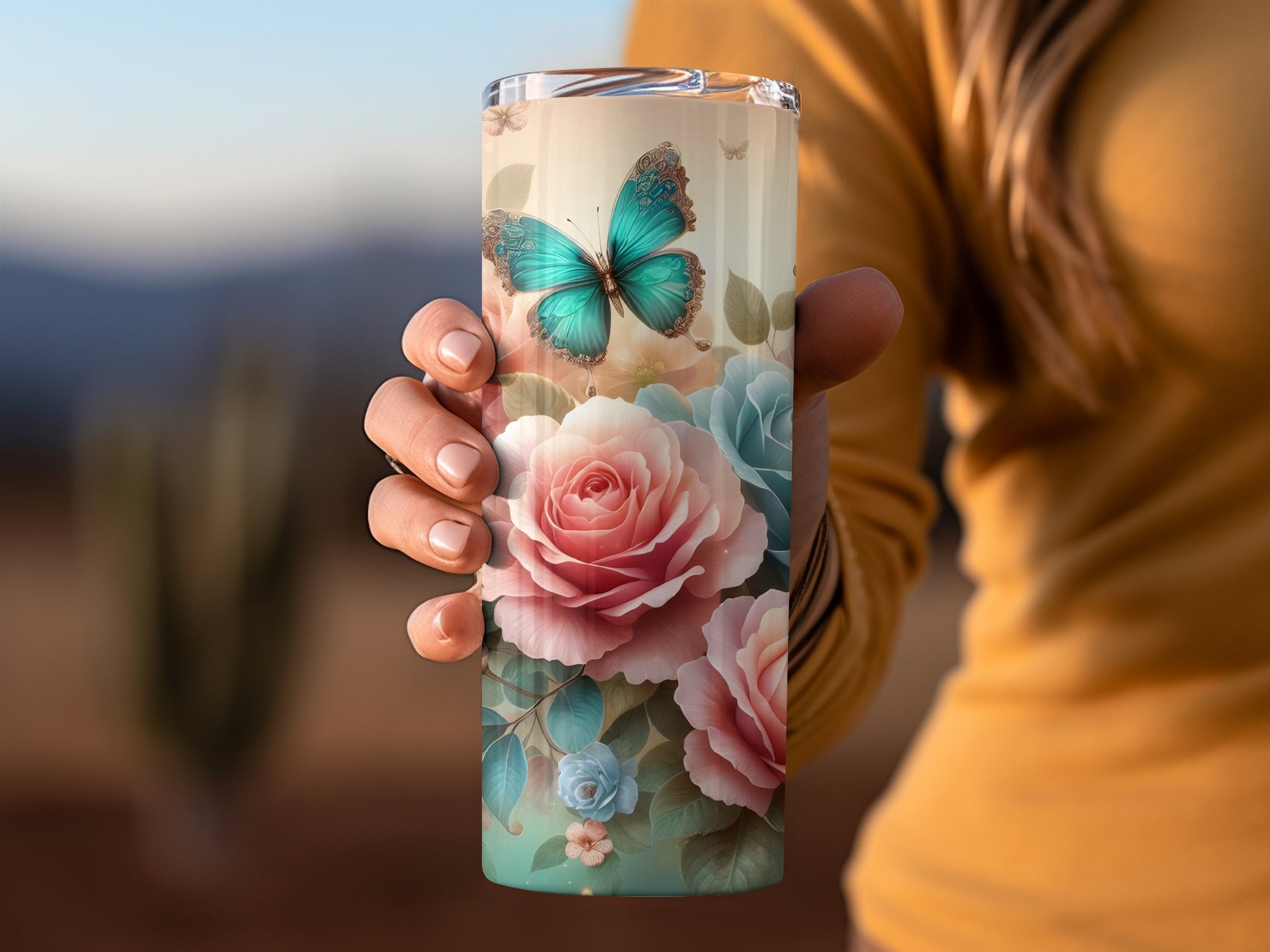 Tumbler with turquoise butterfly and pink and blue roses.
