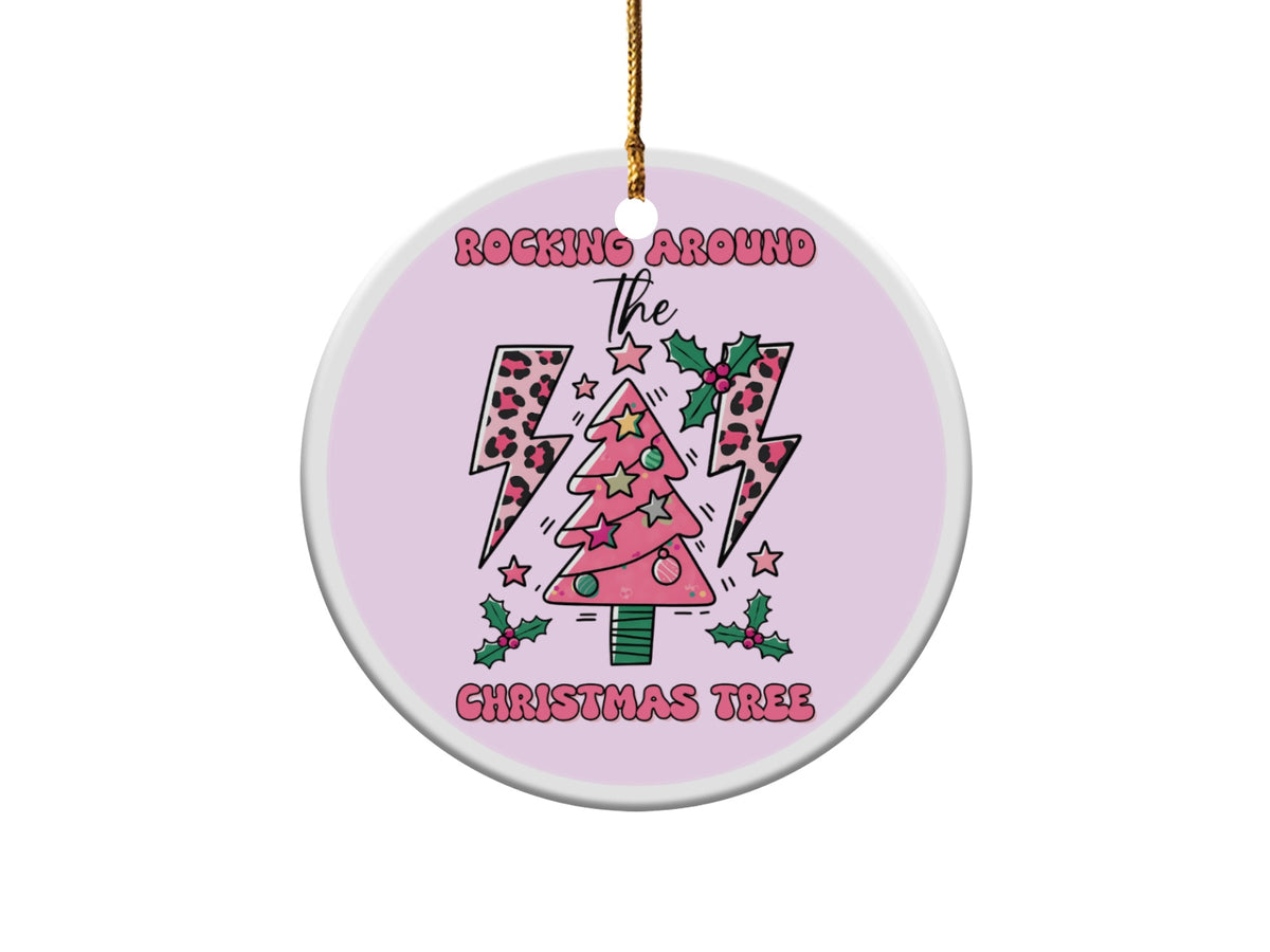 Round ornament with pink Christmas tree, leopard print lightning bolts, holly, and text.