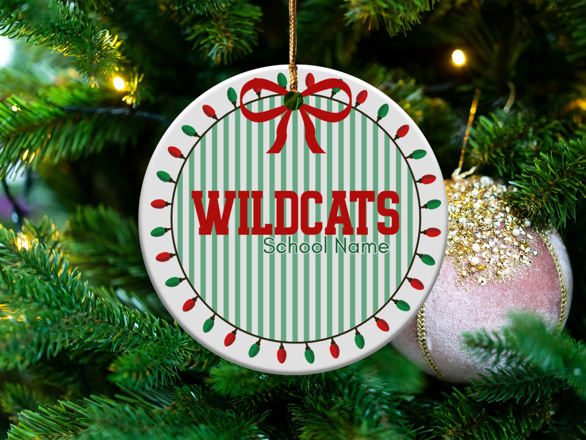 Round ornament with "WILDCATS" and "School Name" on green and white stripes.