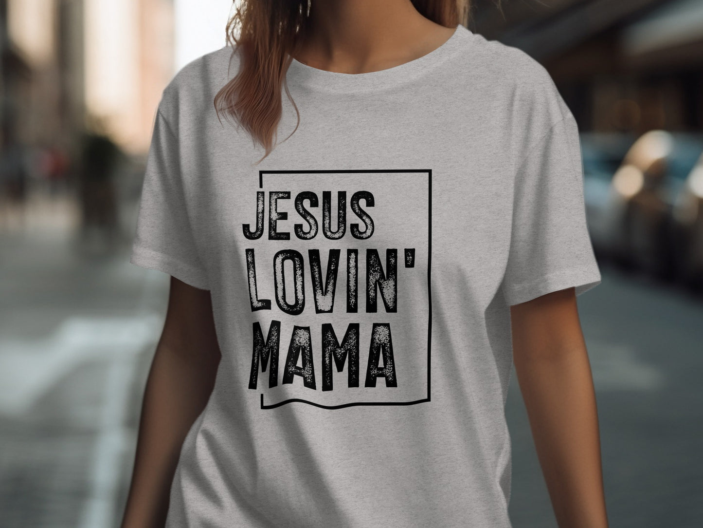 Gray t-shirt with "Jesus Lovin' Mama" text, worn by a woman.