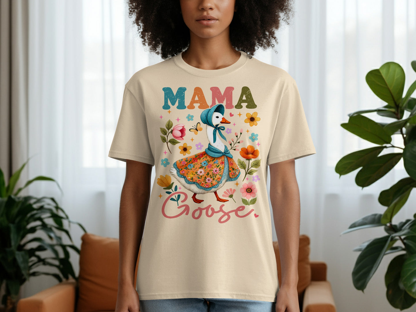 Cream t-shirt with colorful Mama Goose illustration and floral accents.