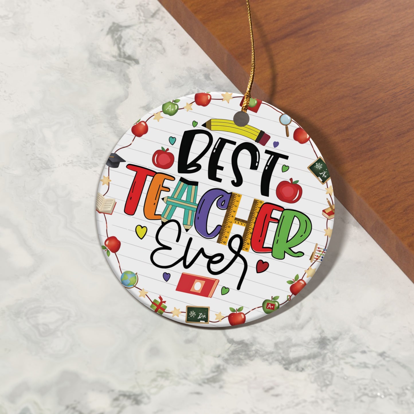 Round ornament with "BEST TEACHER Ever" text and school-themed icons.