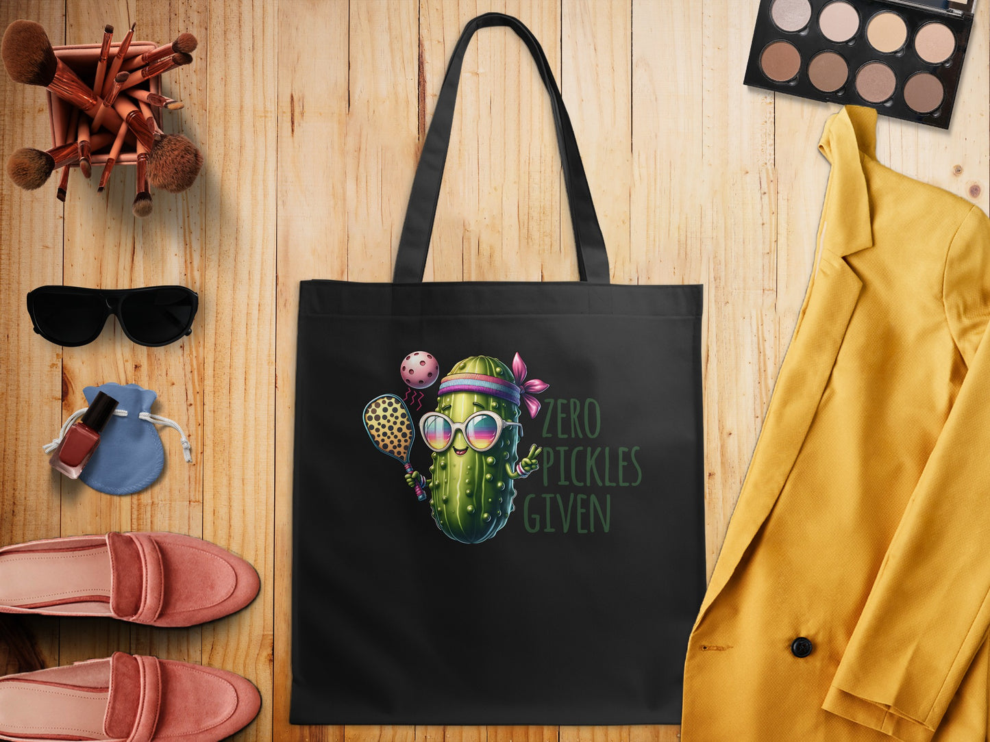 Black tote bag with cartoon pickle wearing sunglasses, playing tennis, and text.