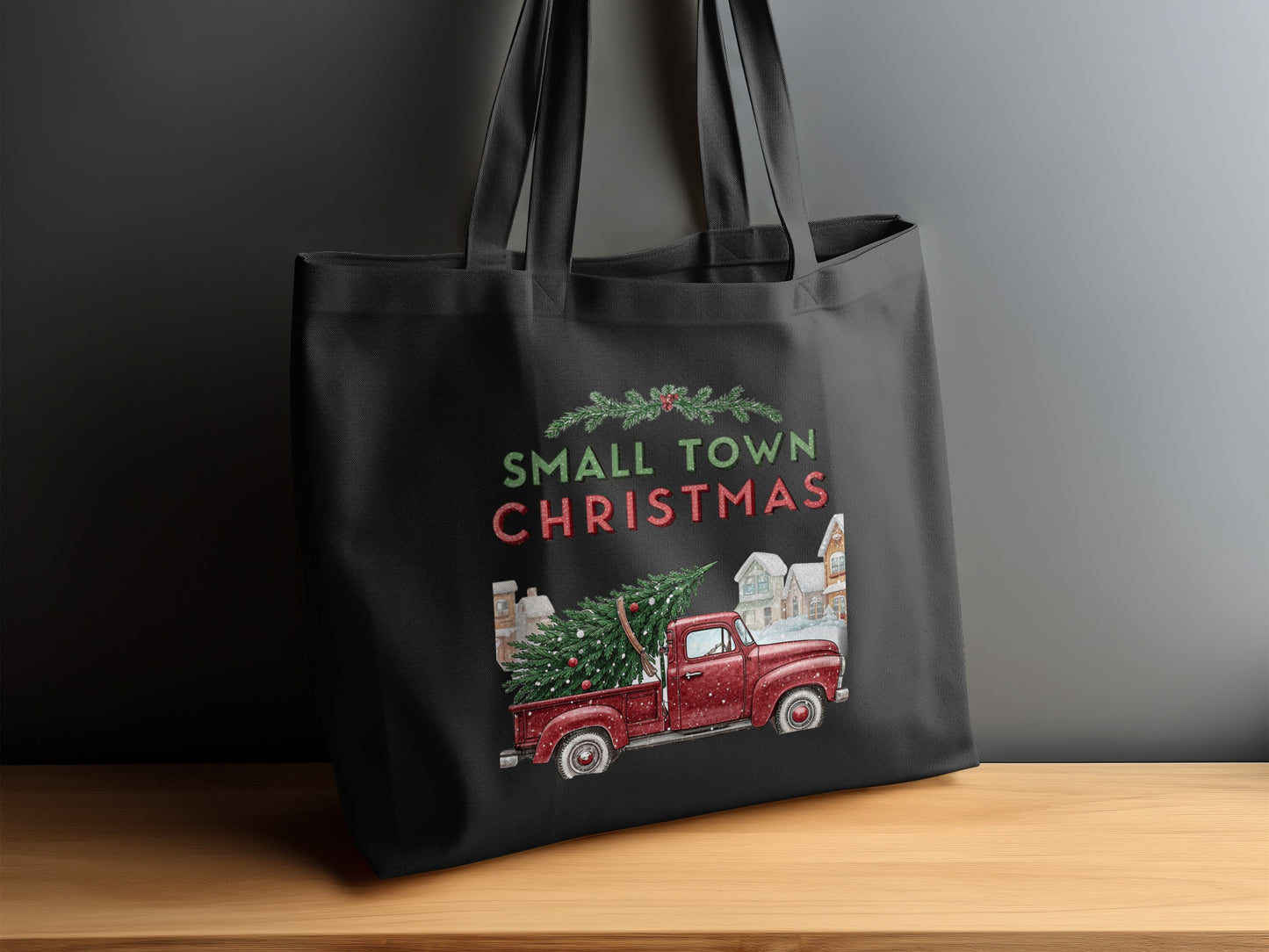 Black tote bag with "Small Town Christmas" text and a vintage red truck.