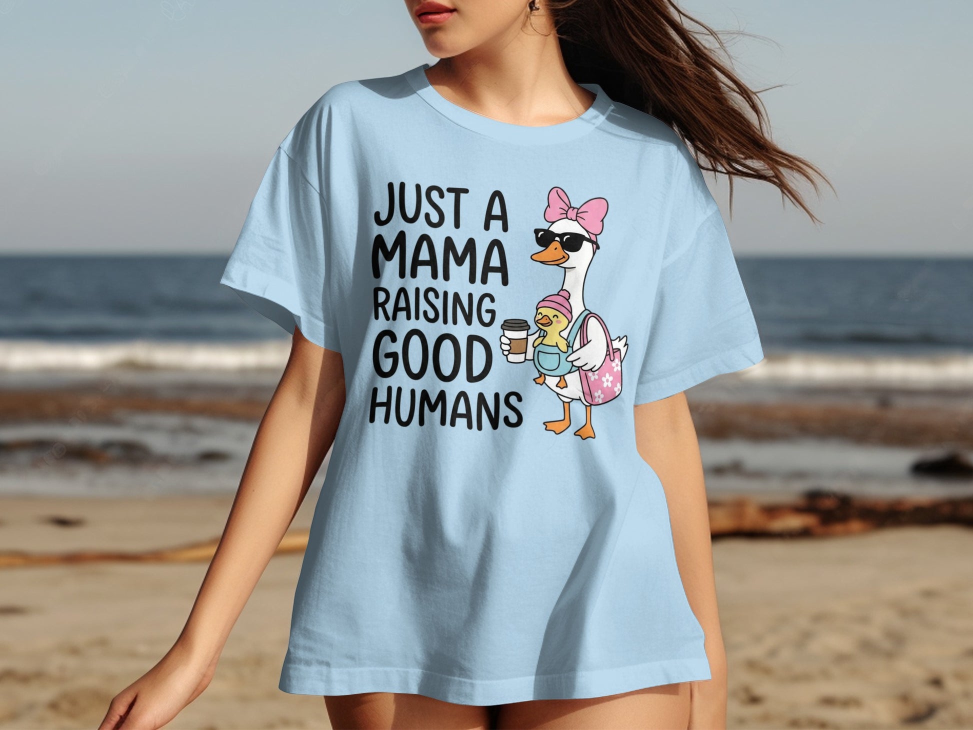 Light blue t-shirt with a mama goose and chick graphic and text.