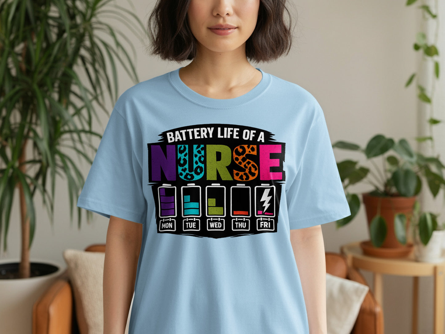 Light blue t-shirt with colorful "Battery Life of a Nurse" text and battery icons.