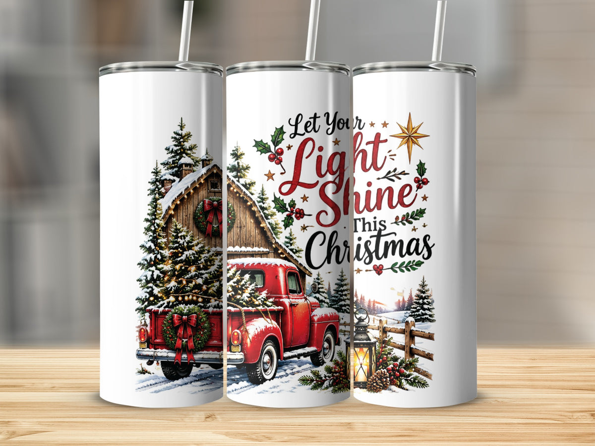 Three white stainless steel tumblers with straws display a Christmas design featuring a red truck and festive text.