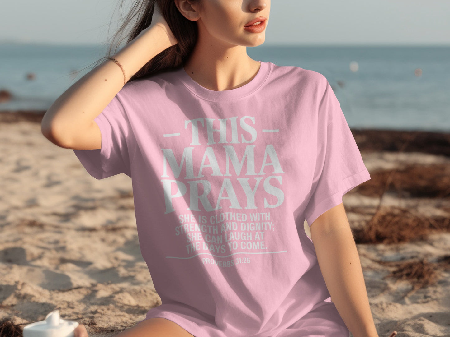Pink t-shirt with text "This Mama Prays Proverbs 31:25".