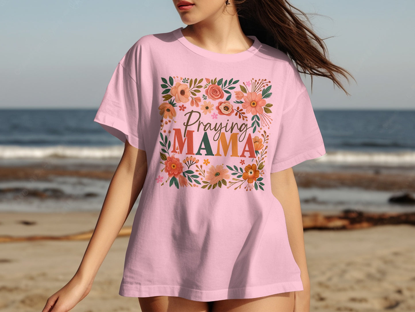 Pink t-shirt with "Praying Mama" and floral wreath design.