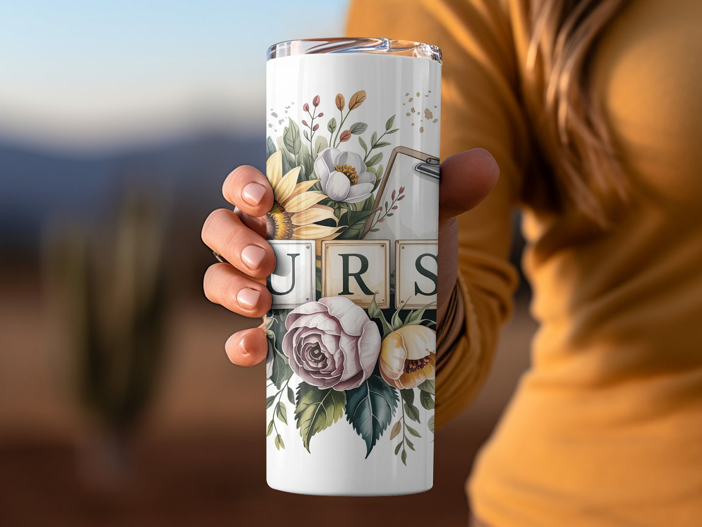 White tumbler with floral design and "URS" spelled out in wooden blocks.