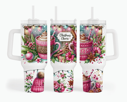 Three views of a white handled tumbler with a clear lid and straw, decorated with a colorful Christmas hot cocoa illustration featuring pink knit sweaters, mugs, candy canes, pinecones, berries, and the words 'Christmas Cheers'.