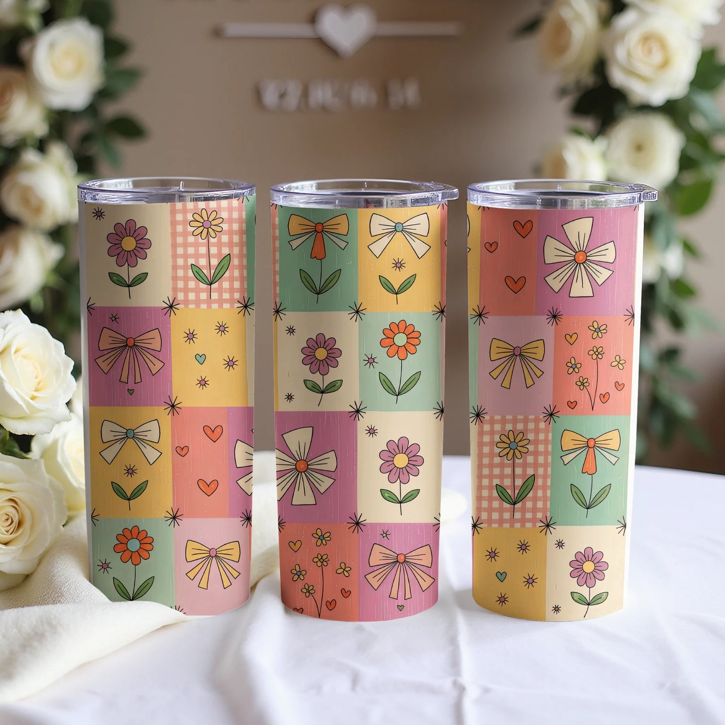 Three floral patchwork tumblers with bows and checkered patterns.